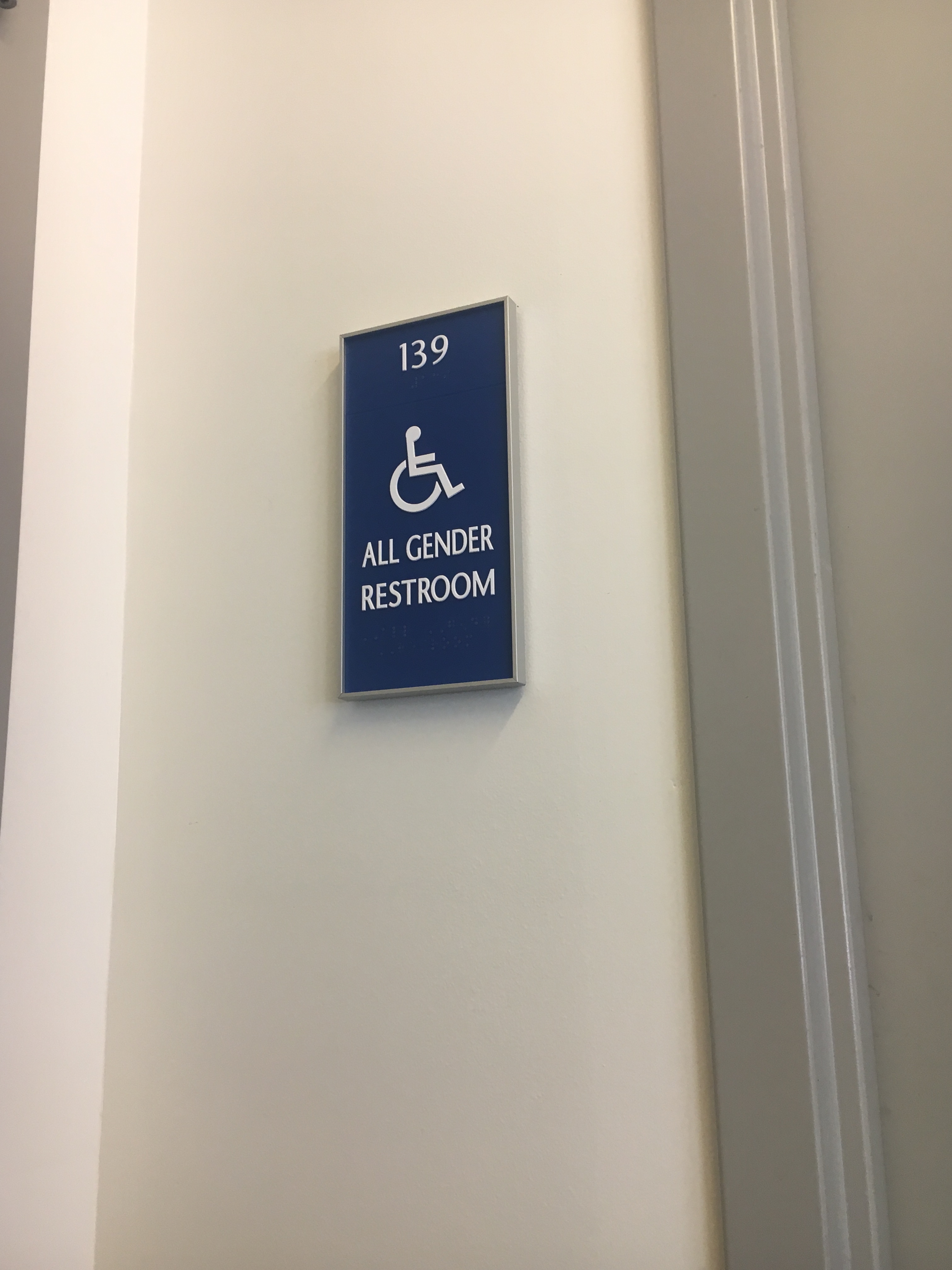 Sign outside companion/ all-gender bathroom indicating accessibility