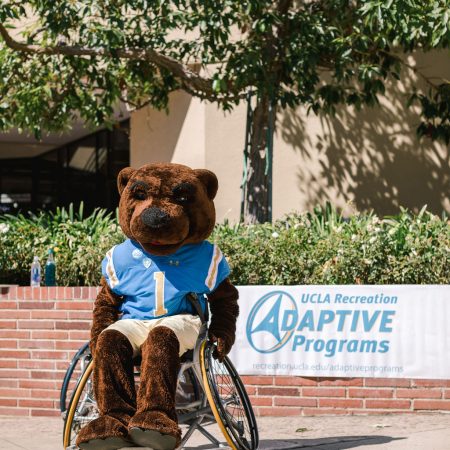 Joe Bruin tries out a sports wheelchair