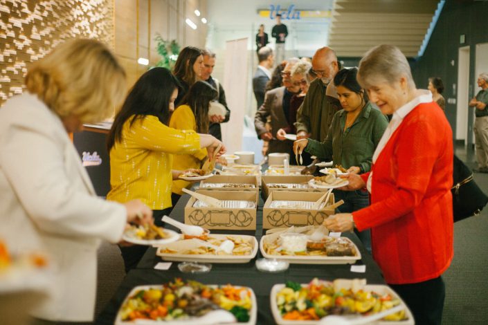 People serve themselves at buffet style spread.