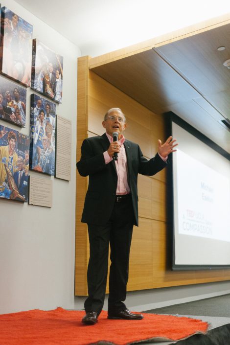 Man holding a microphone gives a talk.