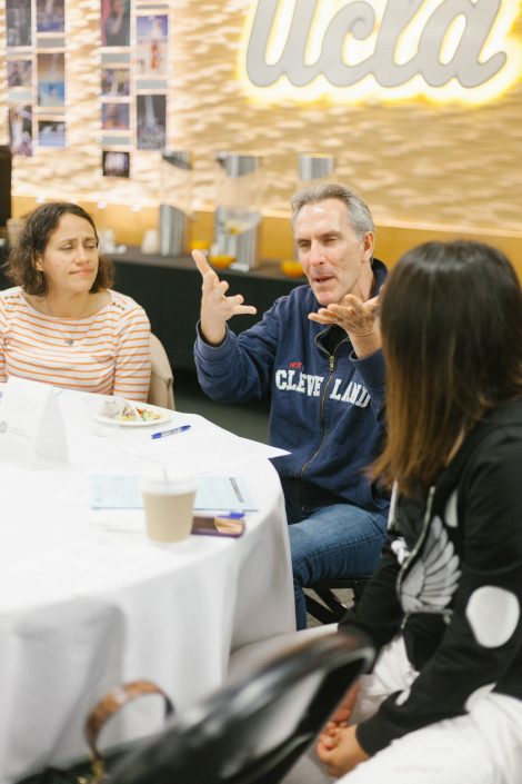 Man talks to two women.