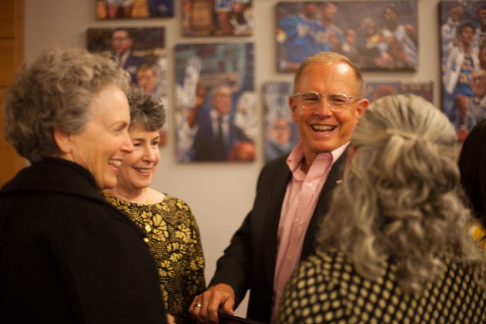 Two woman and a man laugh.