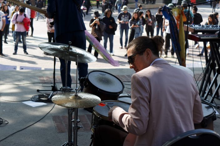Man plays the drums.