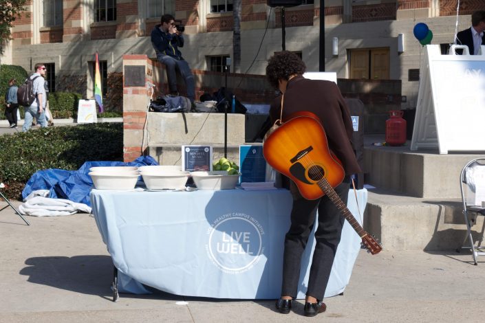 Man with a guitar checks out the LiveWEell table.